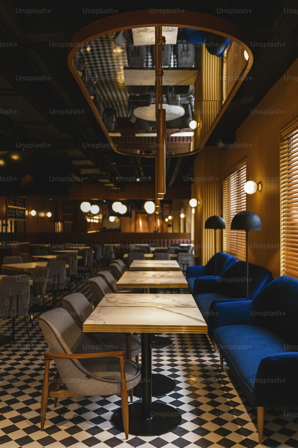 a restaurant with a checkered floor and a long table