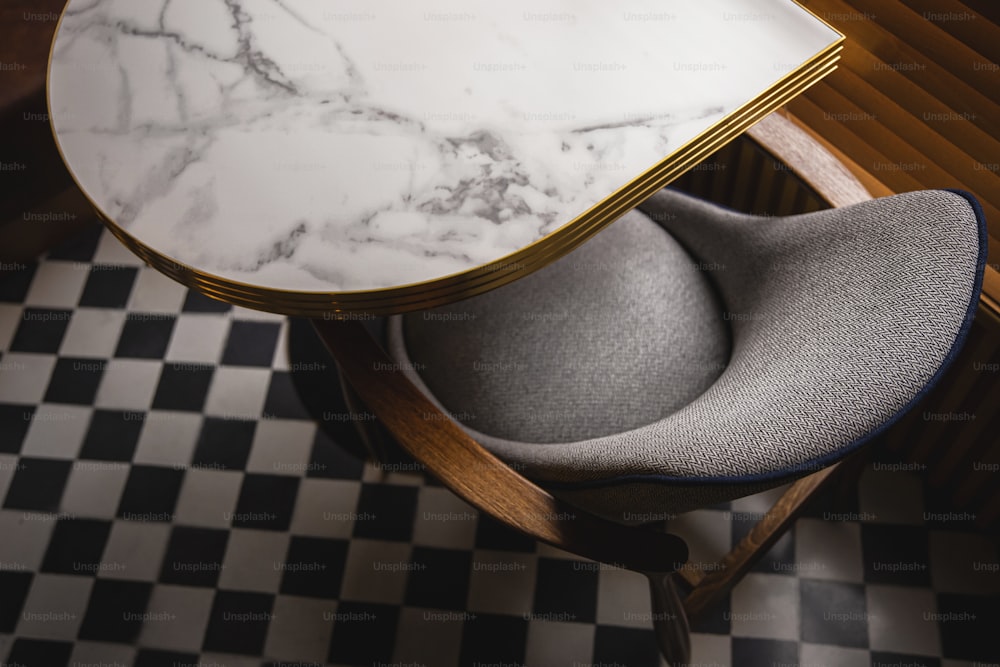 a marble topped table with a chair underneath it