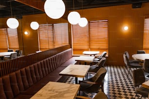 a restaurant with a checkered floor and wooden walls