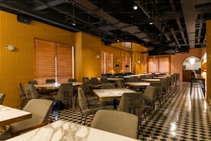 a restaurant with a checkered floor and yellow walls