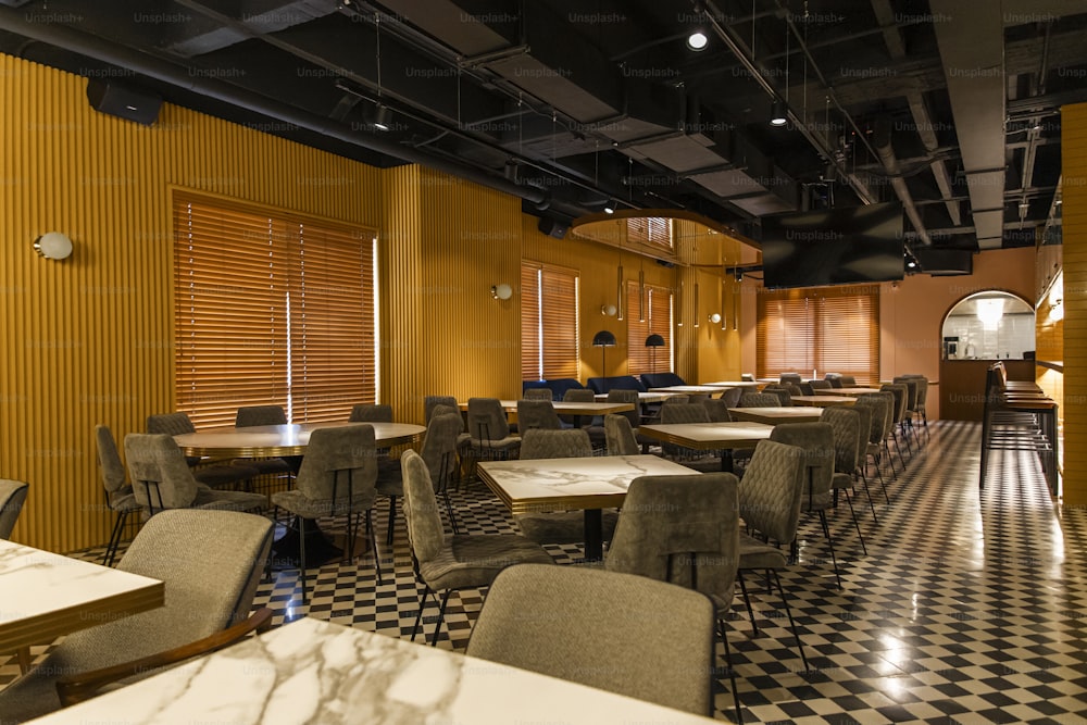 a restaurant with a checkered floor and yellow walls