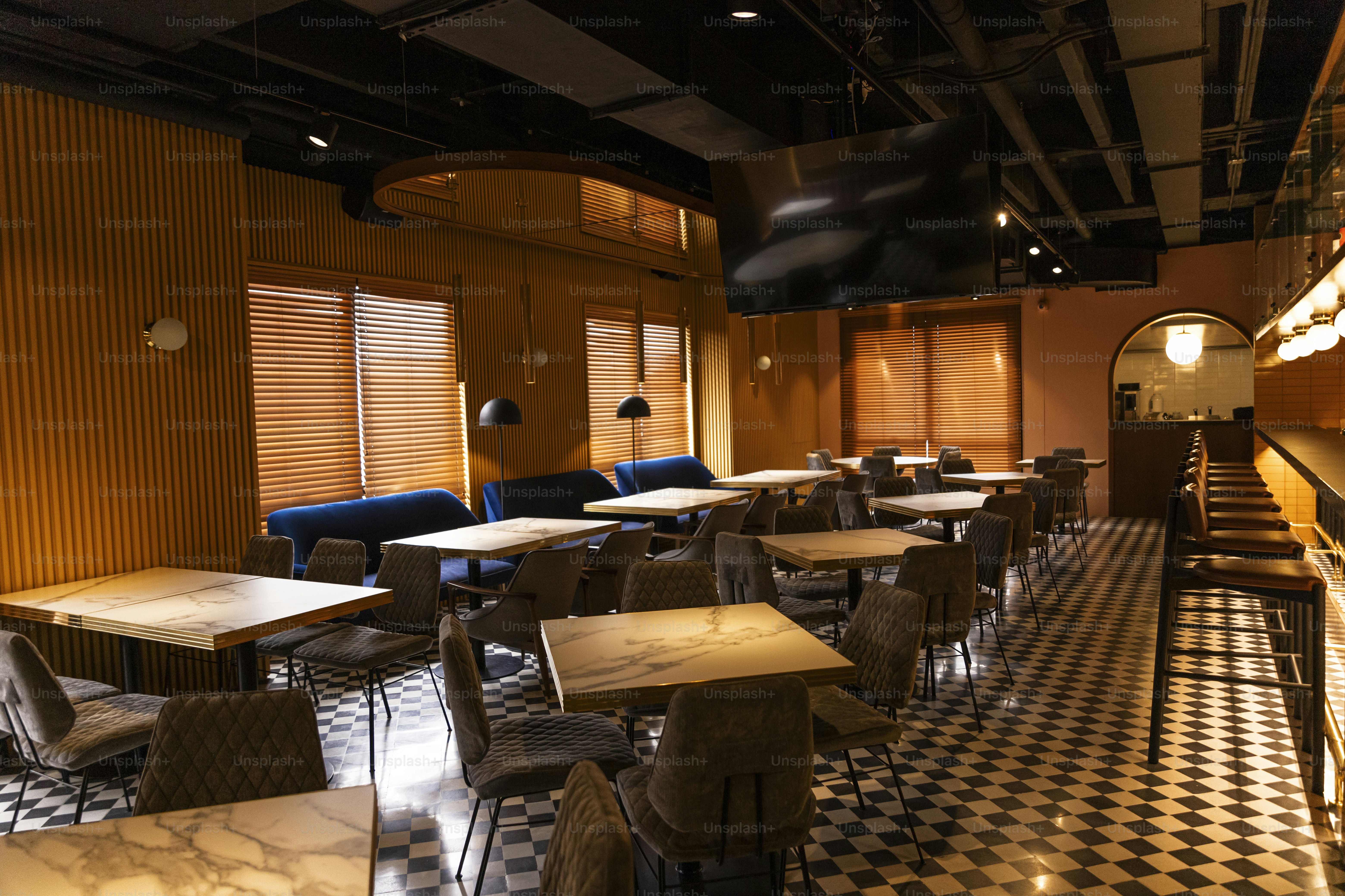 a restaurant with a checkered floor and wooden walls