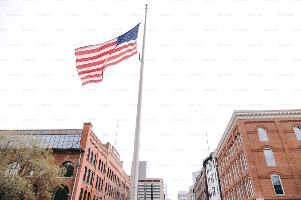 a large american flag is flying in the air