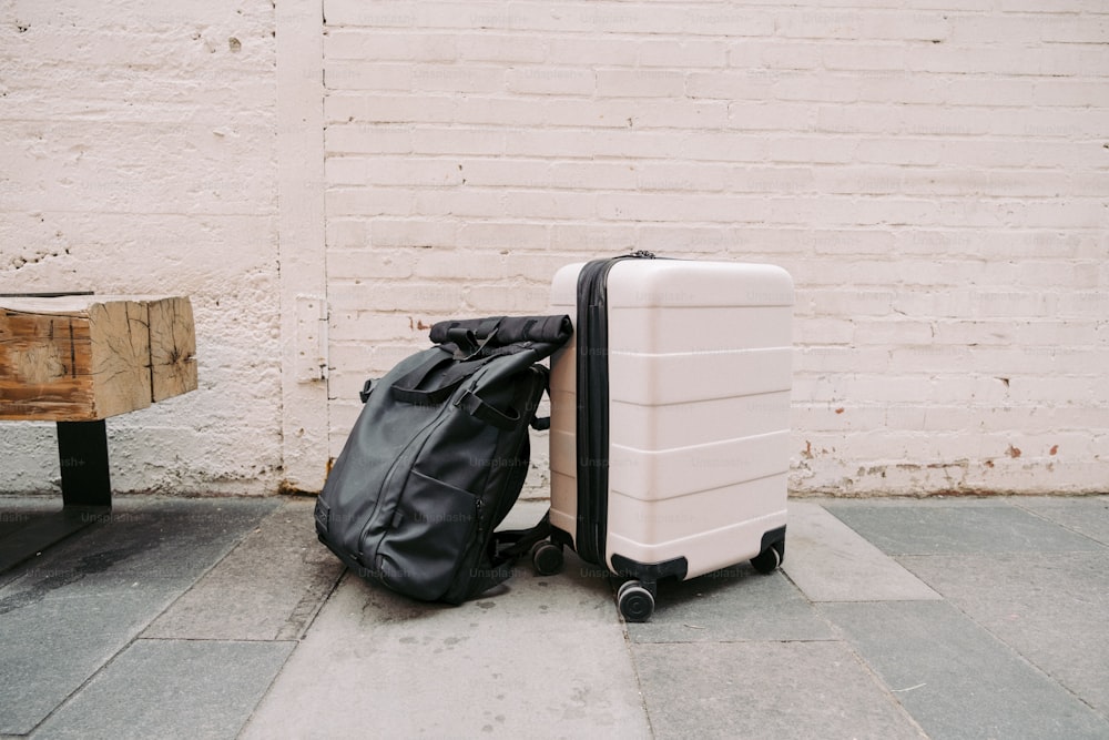 a piece of luggage sitting on the ground next to a wall