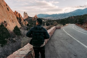 a man standing on the side of a road