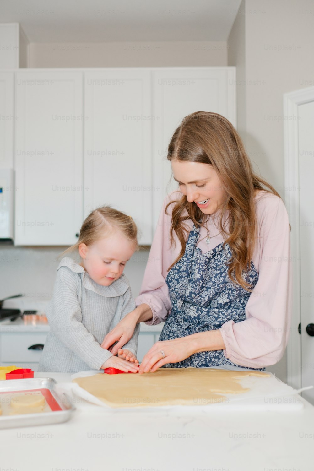 a woman and a child are in the kitchen