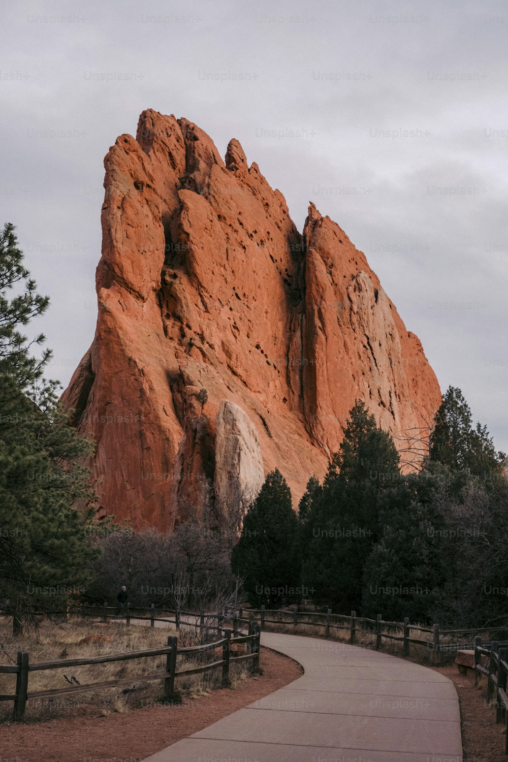 a path in front of a large rock formation