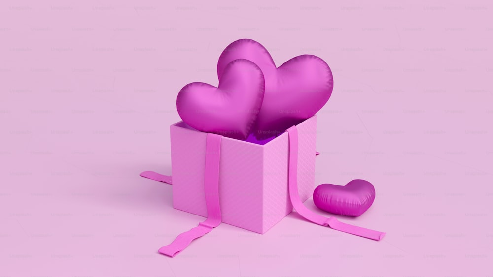 uma caixa de presente rosa com corações em um fundo cor-de-rosa