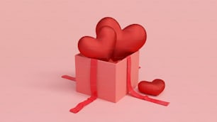 Una caja de regalo roja con dos corazones sobre un fondo rosa
