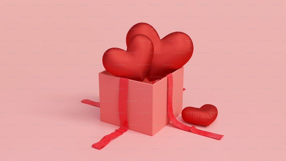 uma caixa de presente vermelha com dois corações em um fundo cor-de-rosa