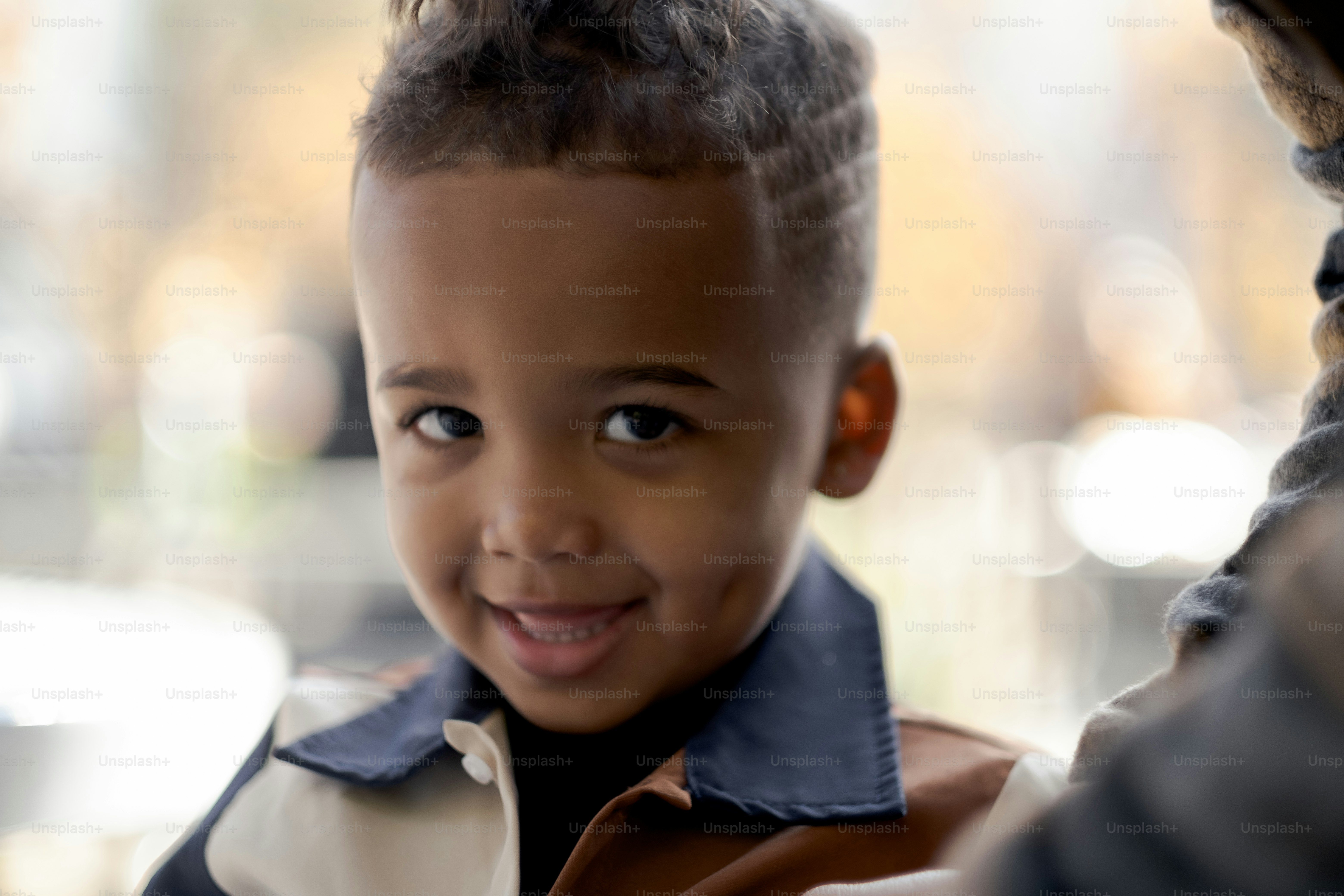 a little boy that is smiling for the camera