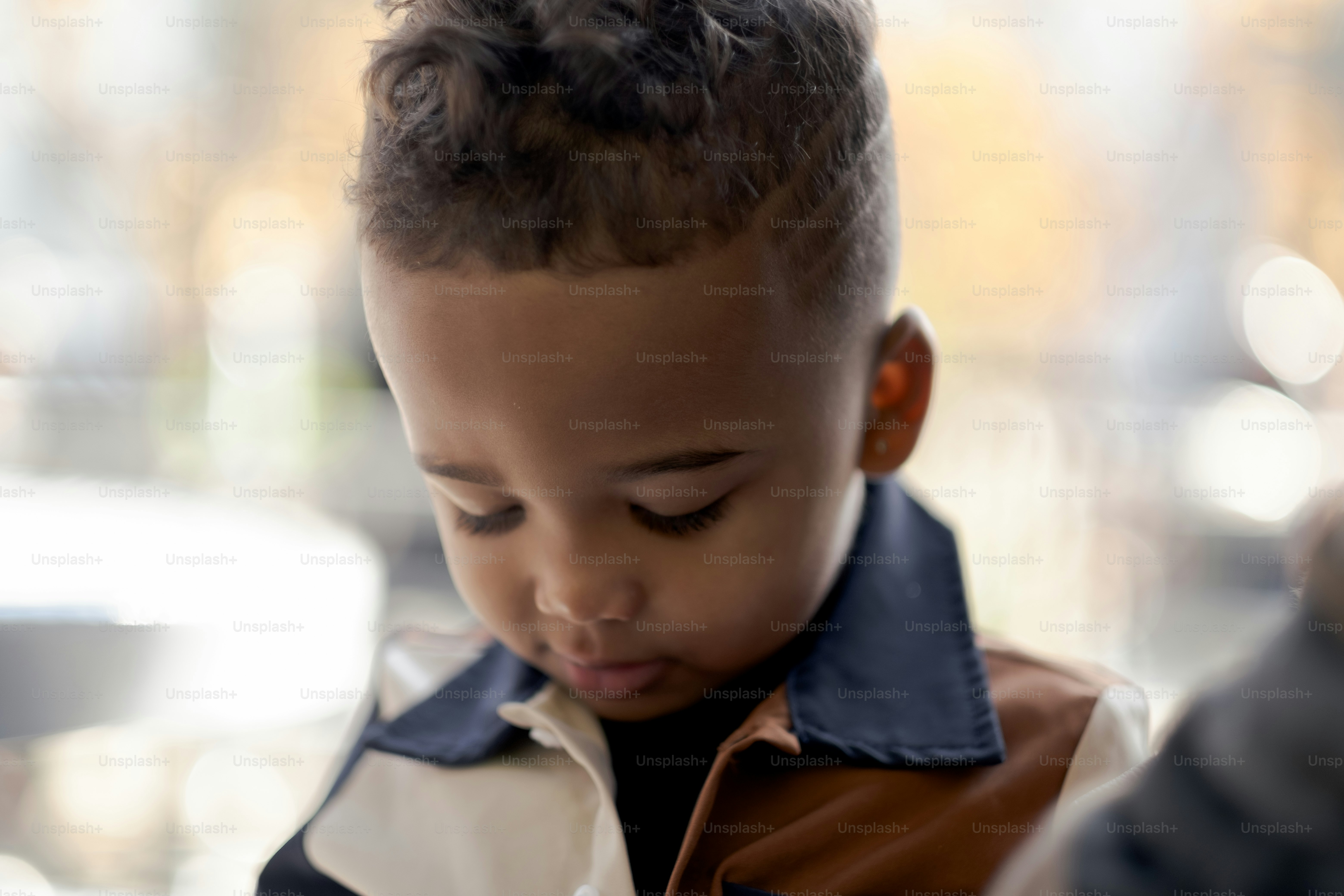 a little boy that is looking at a cell phone