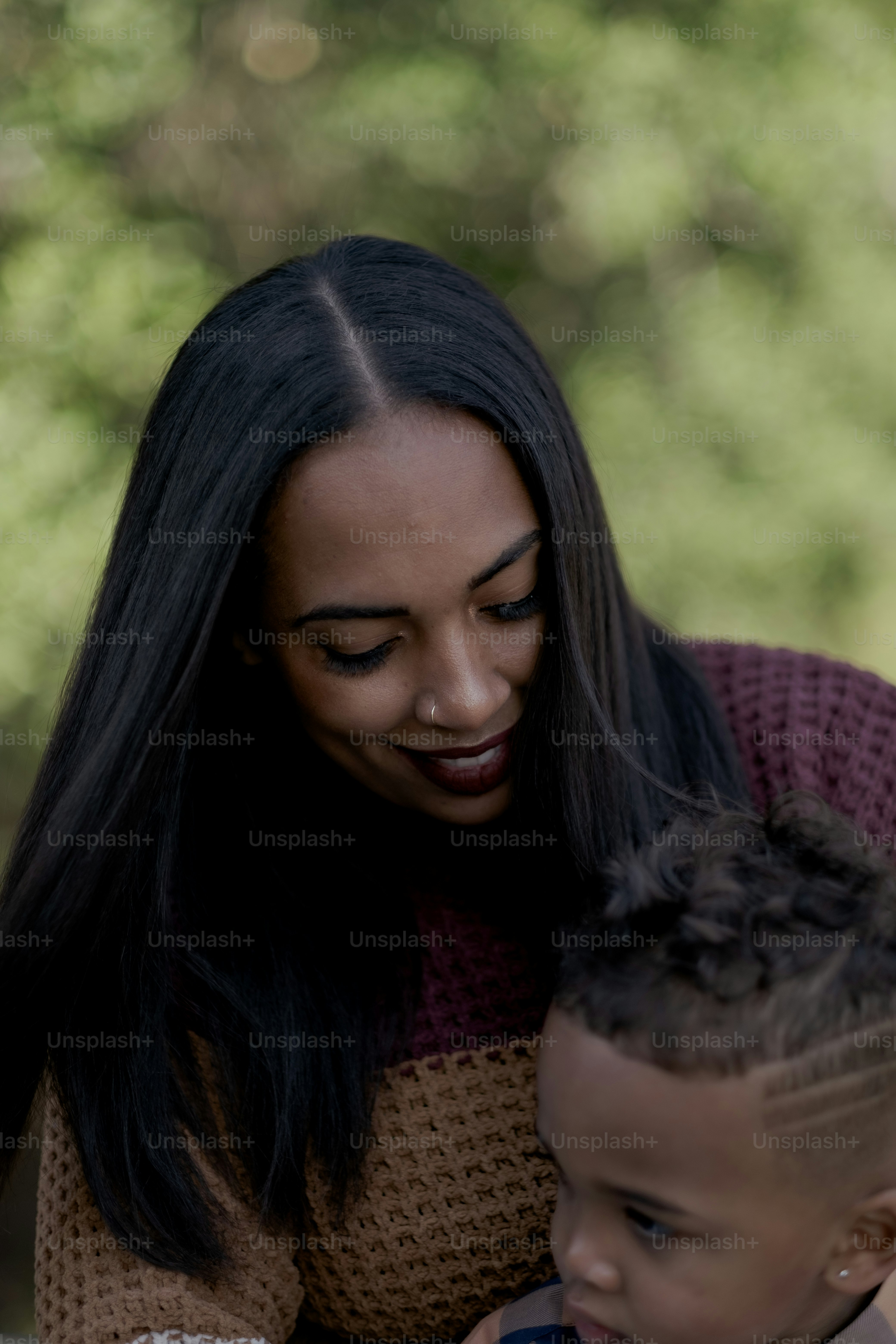 a woman and a child looking at a cell phone