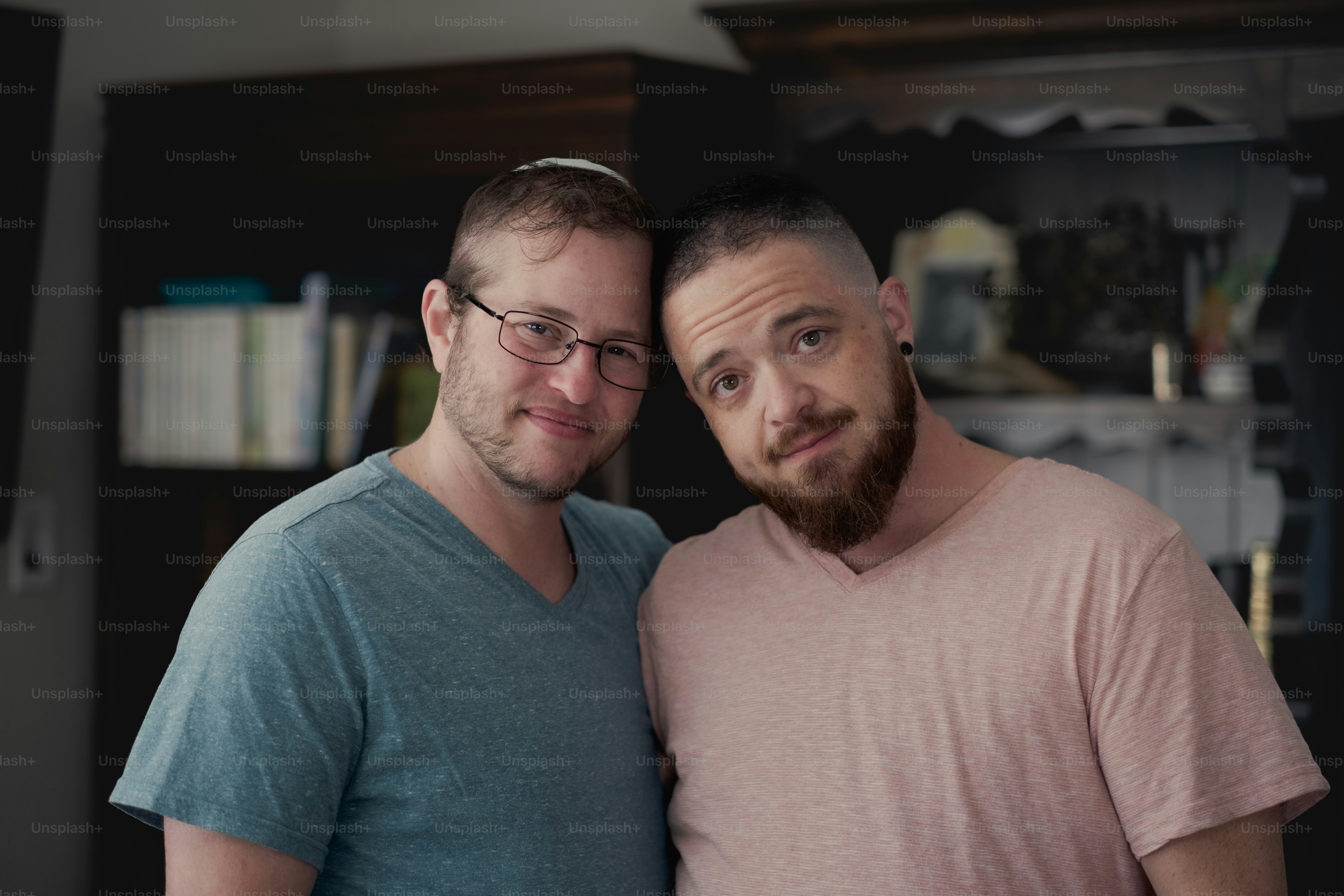 Joshua and Rafi at their home, expressing their love and affection for one other. They maintain a Jewish household for themselves and for their children. Both Joshua and Rafi are active in Jewish causes, and are men of trans experience.