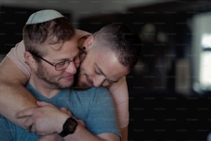 a couple of men hugging each other in a room