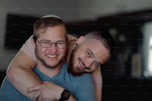 two men hugging each other in a living room