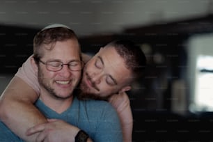 a couple of men hugging each other in a room