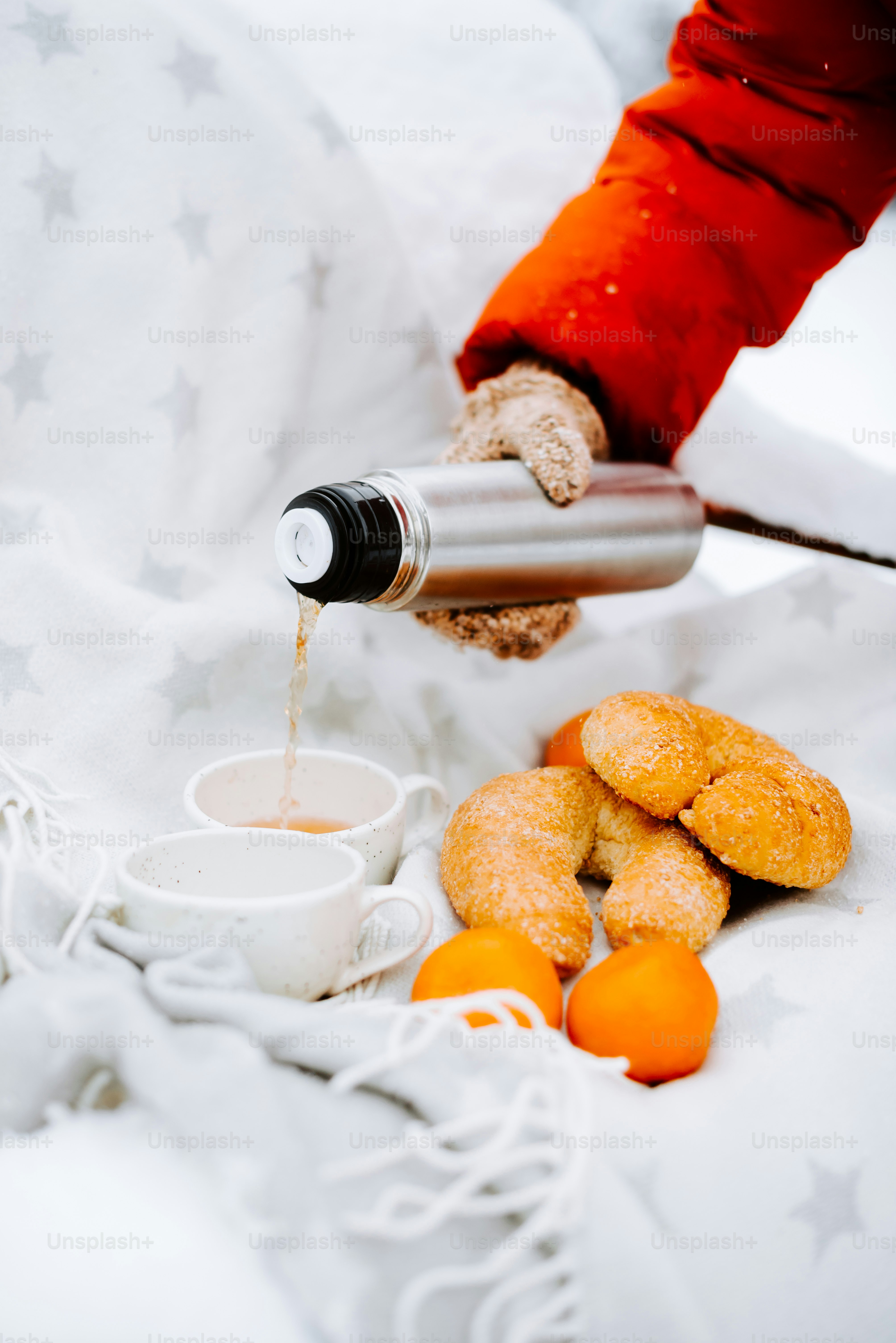 a person is pouring something into a cup