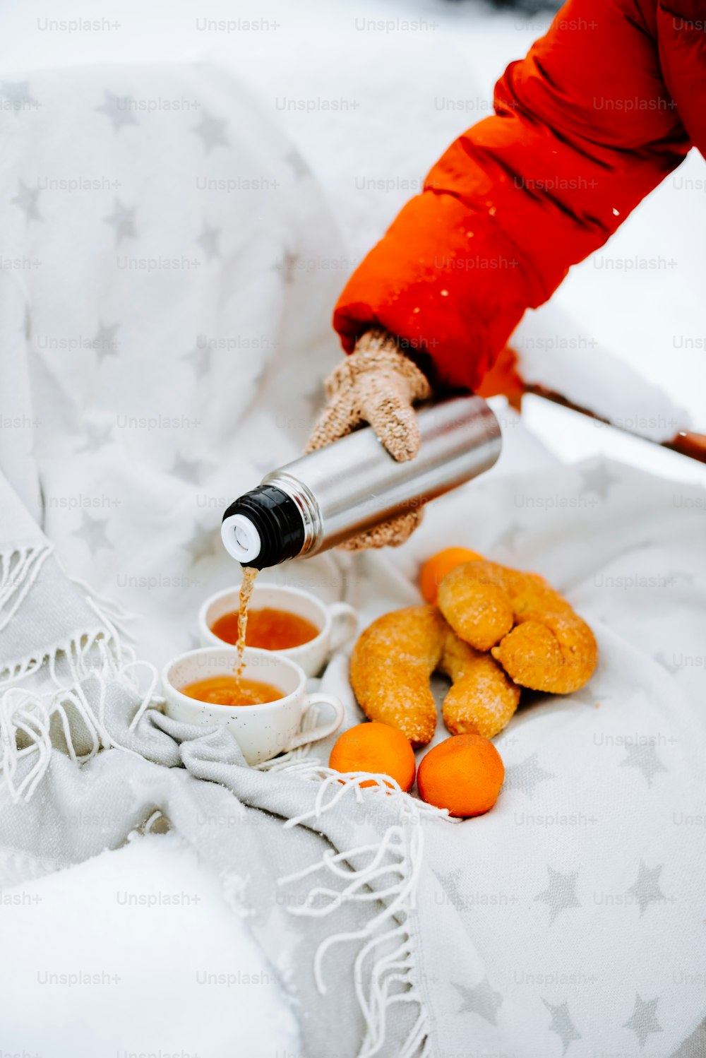 a person pouring something into small cups