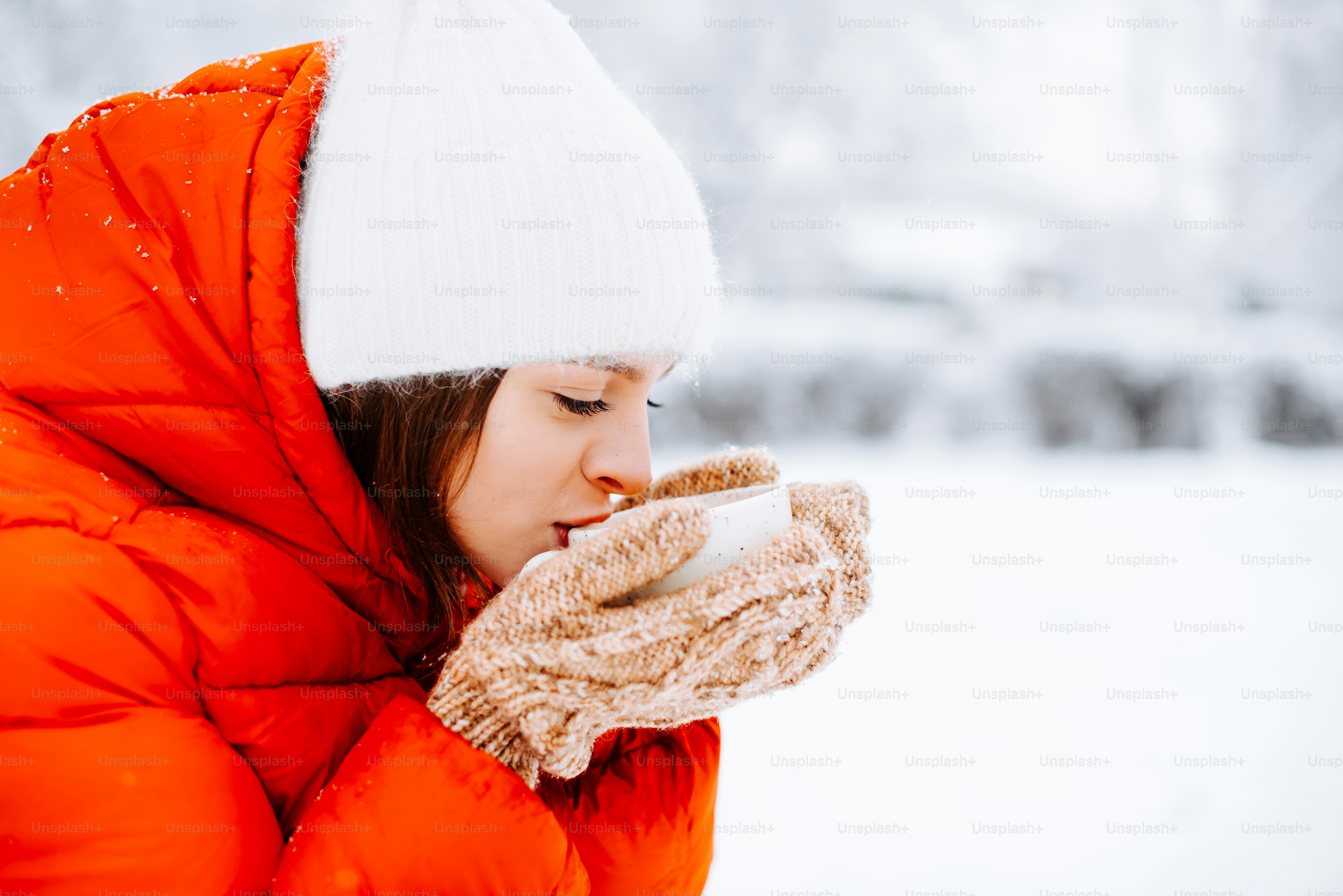 A woman in a red coat is drinking from a cup photo – Food Image on Unsplash