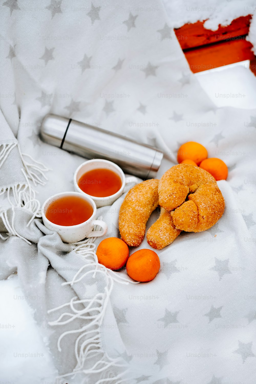uma mesa coberta com laranjas e xícaras de chá