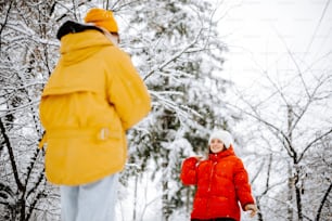 a woman in a red jacket is walking in the snow