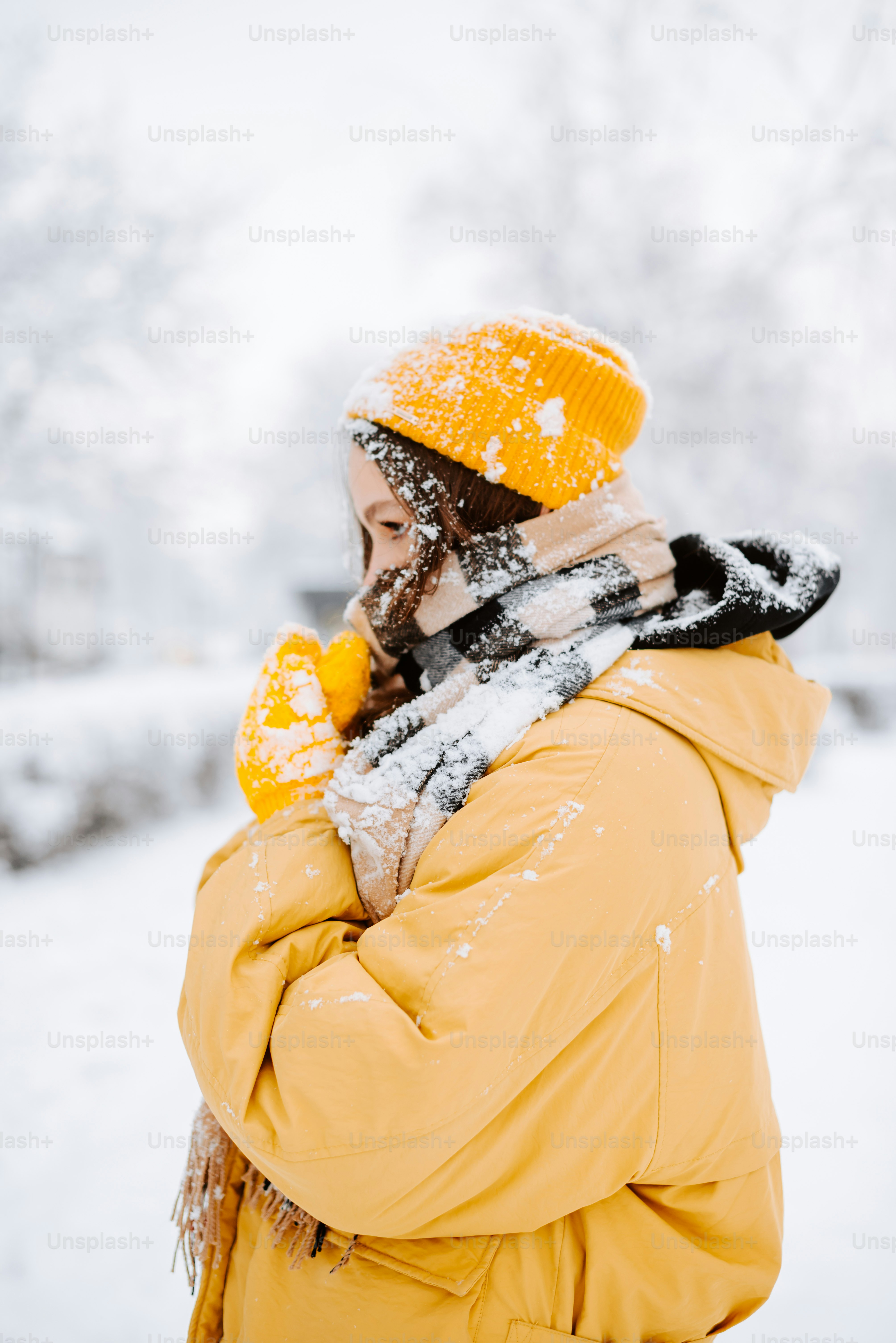 a woman wearing a yellow coat and a yellow hat