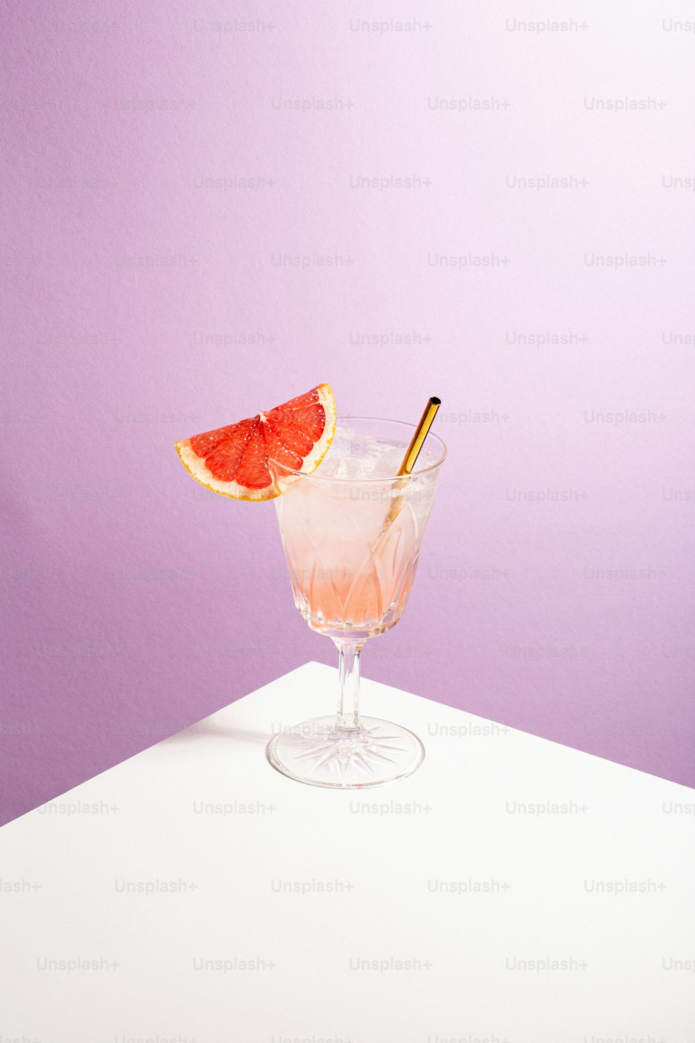 a grapefruit cocktail garnished with a slice of grapefruit