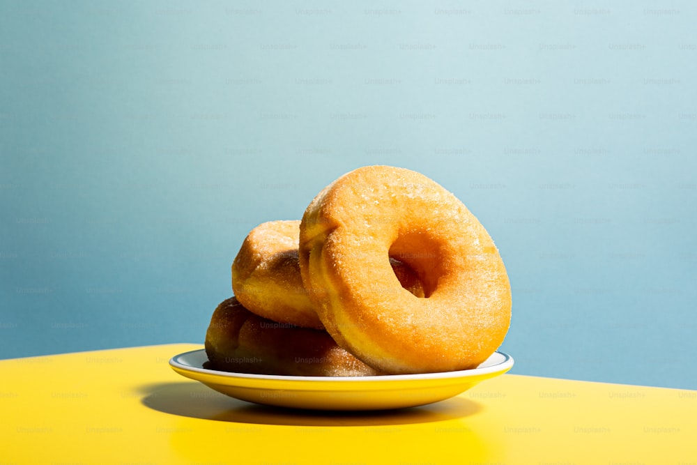 a couple of doughnuts sitting on top of a yellow plate