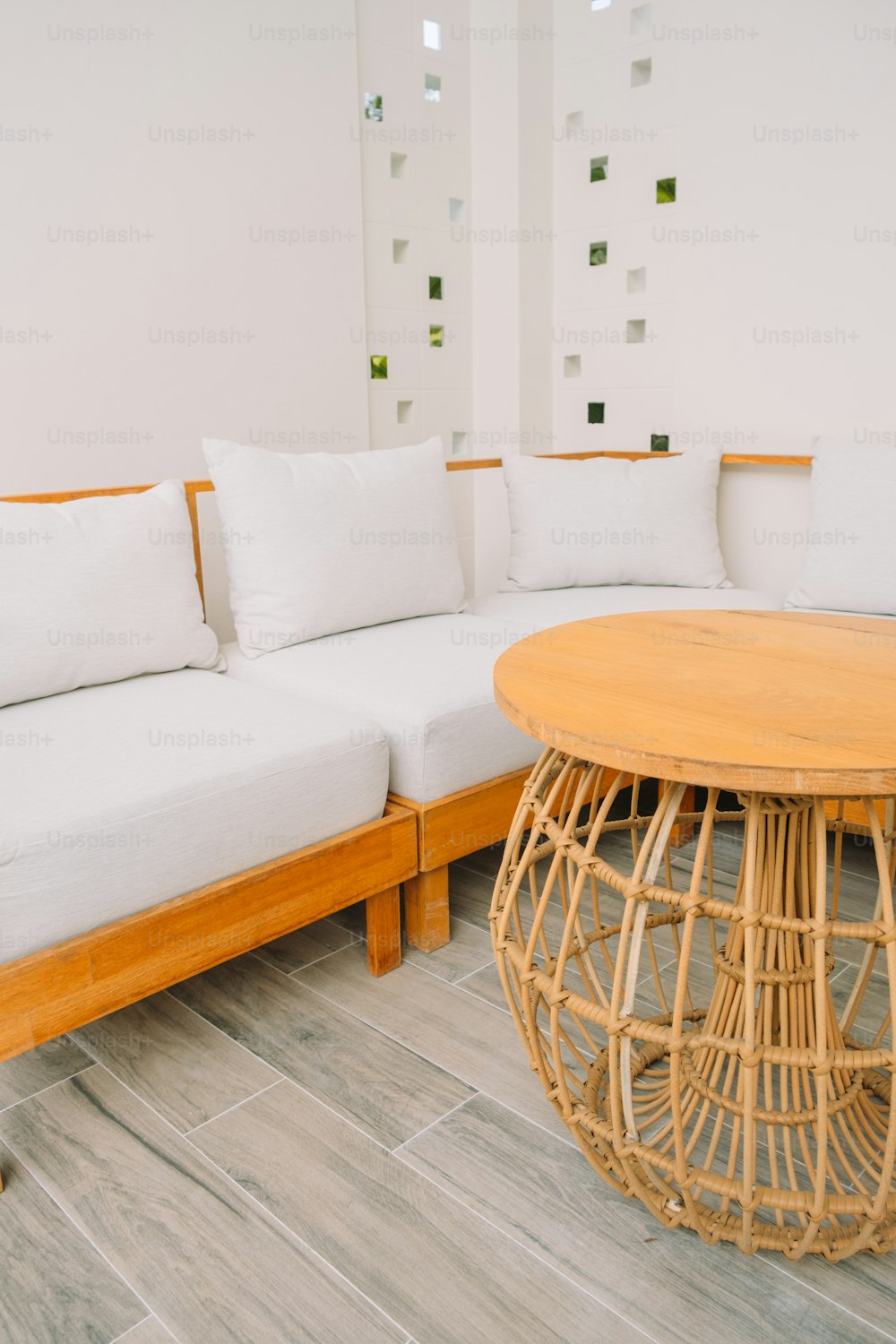 a wooden table sitting next to a white couch