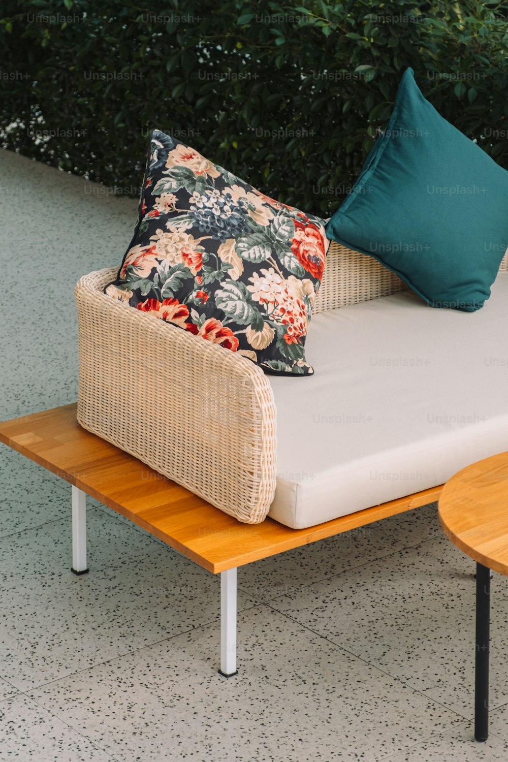 a couch with a pillow on top of it next to a table