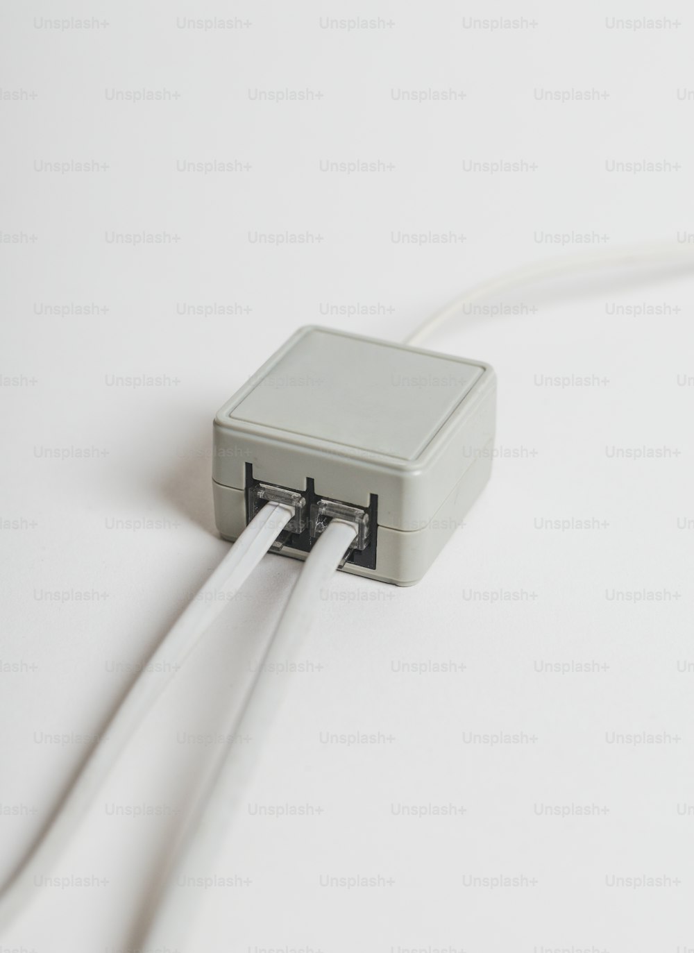 a white box connected to a white cord