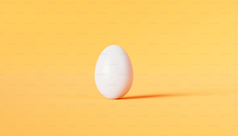 a white egg on a yellow background