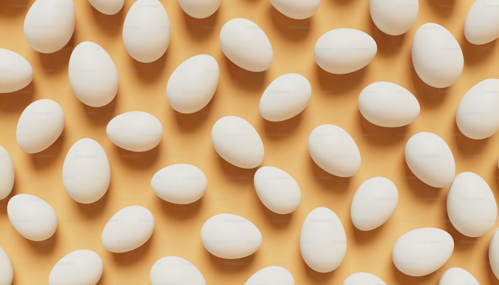 a bunch of white eggs on a brown surface