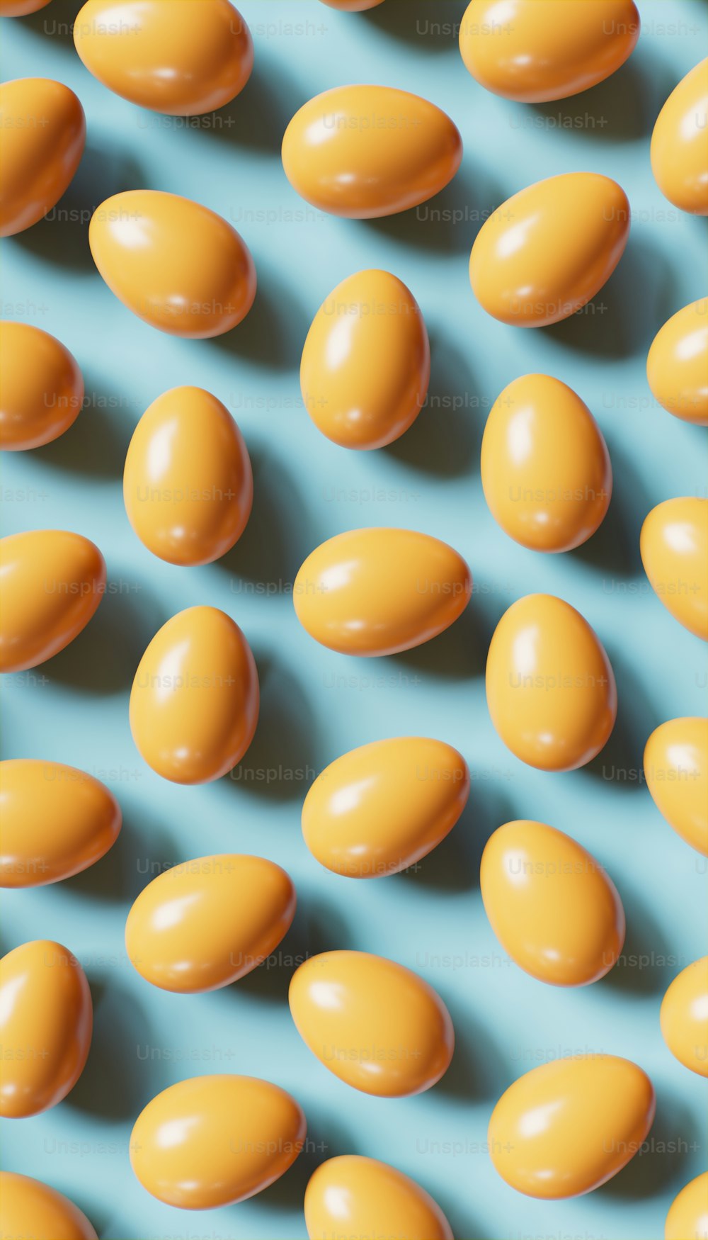 a bunch of yellow eggs sitting on top of a blue surface