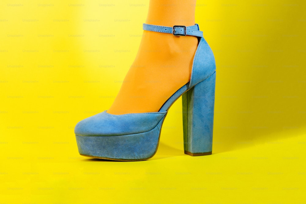 a woman's blue and yellow high heeled shoes