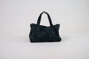 a black bag sitting on top of a white table