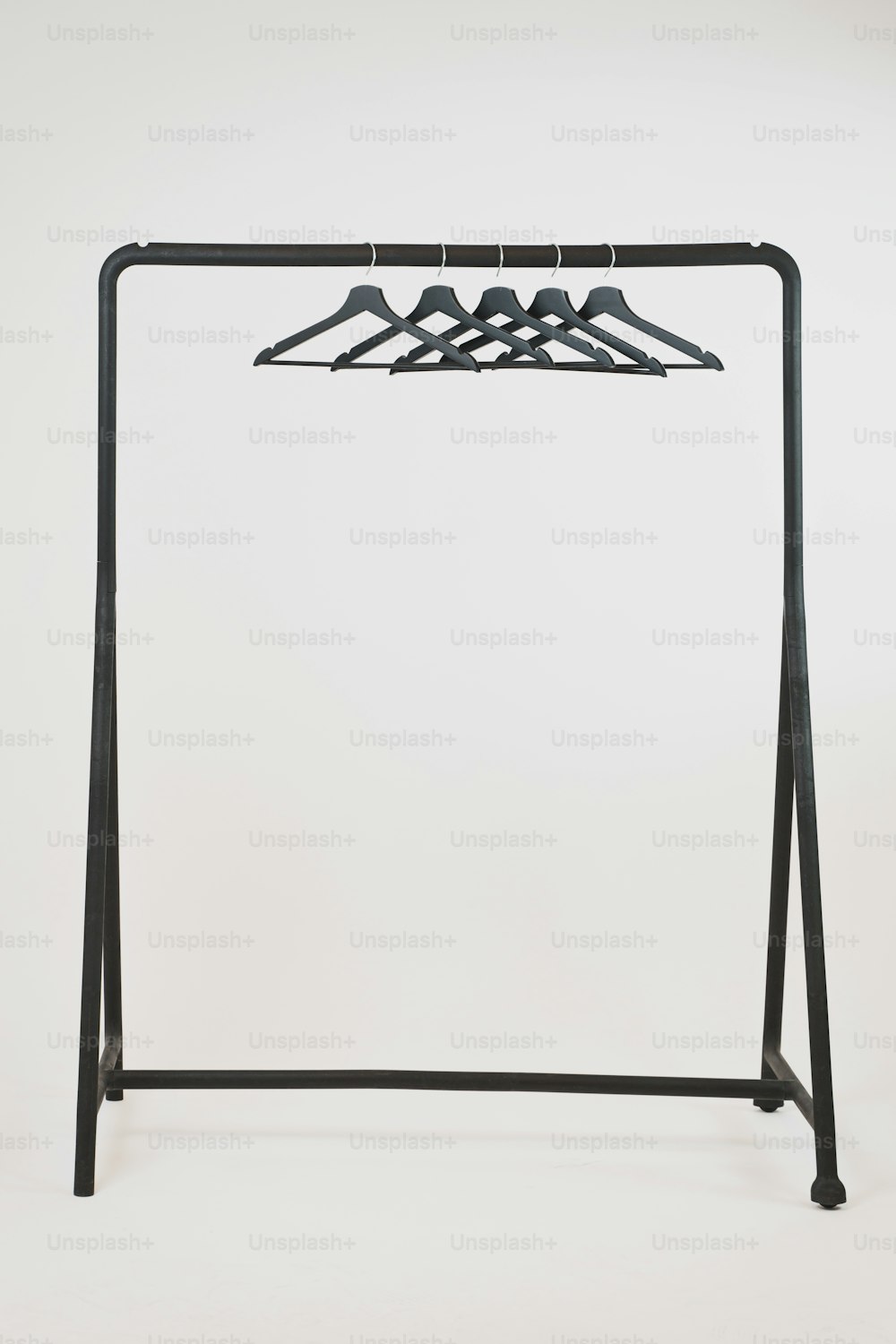 a clothes rack with four hangers on it