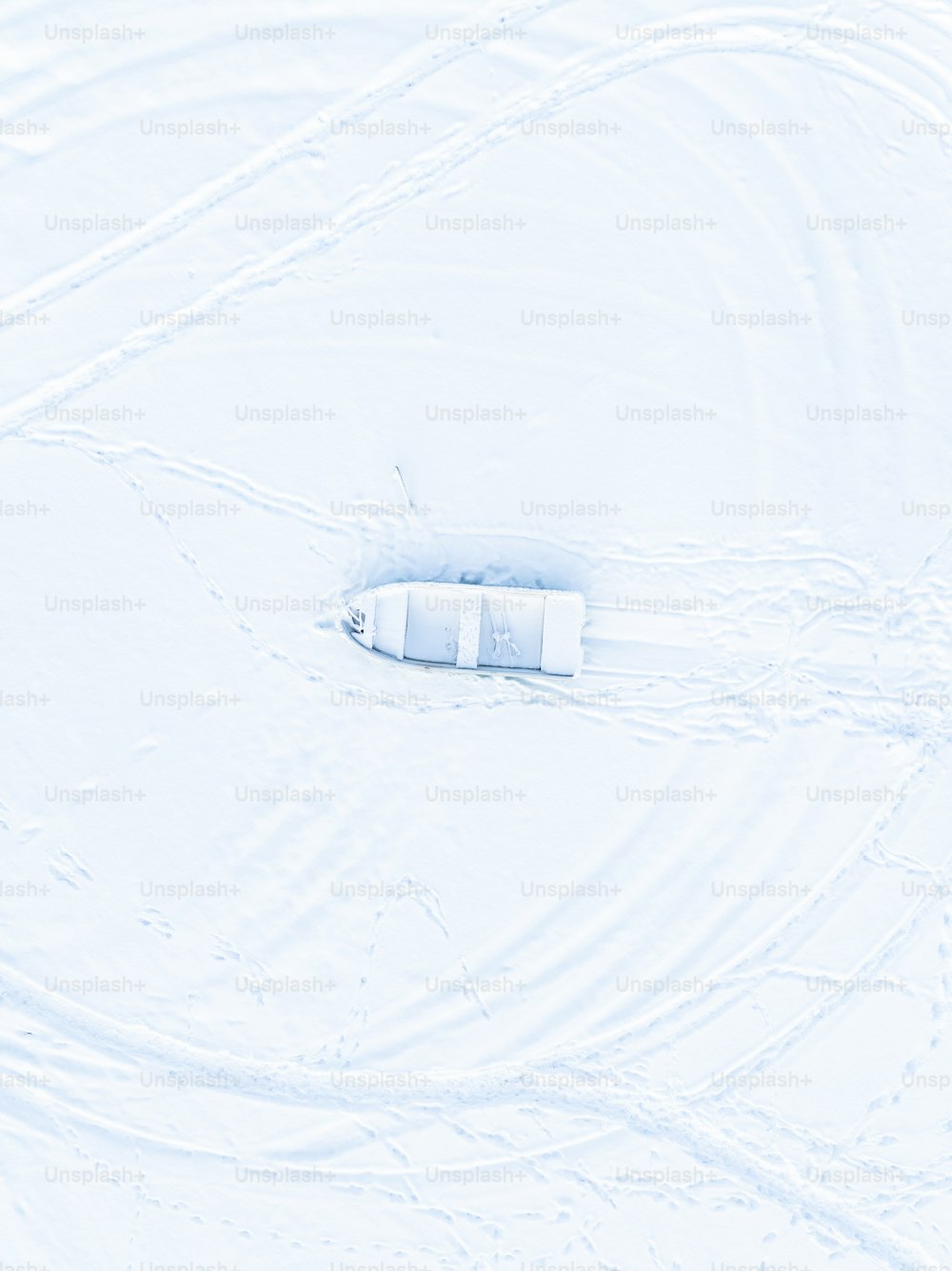 an aerial view of a snow covered field