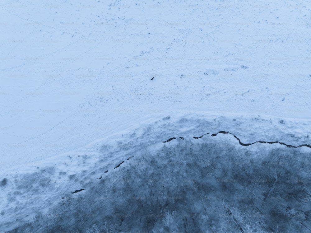 a man riding a snowboard down a snow covered slope