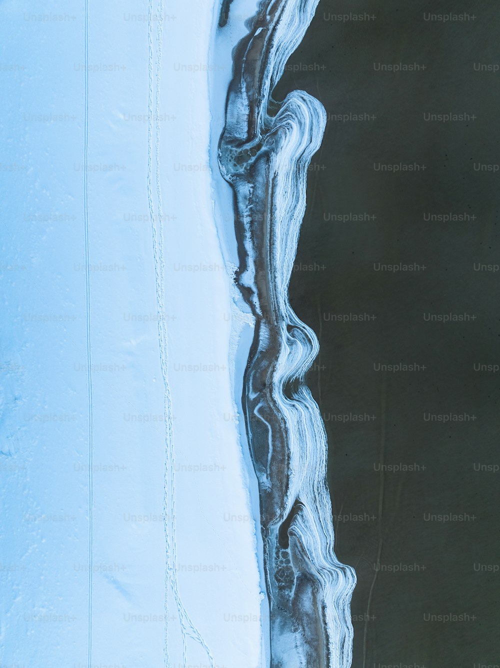 an aerial view of a body of water covered in ice