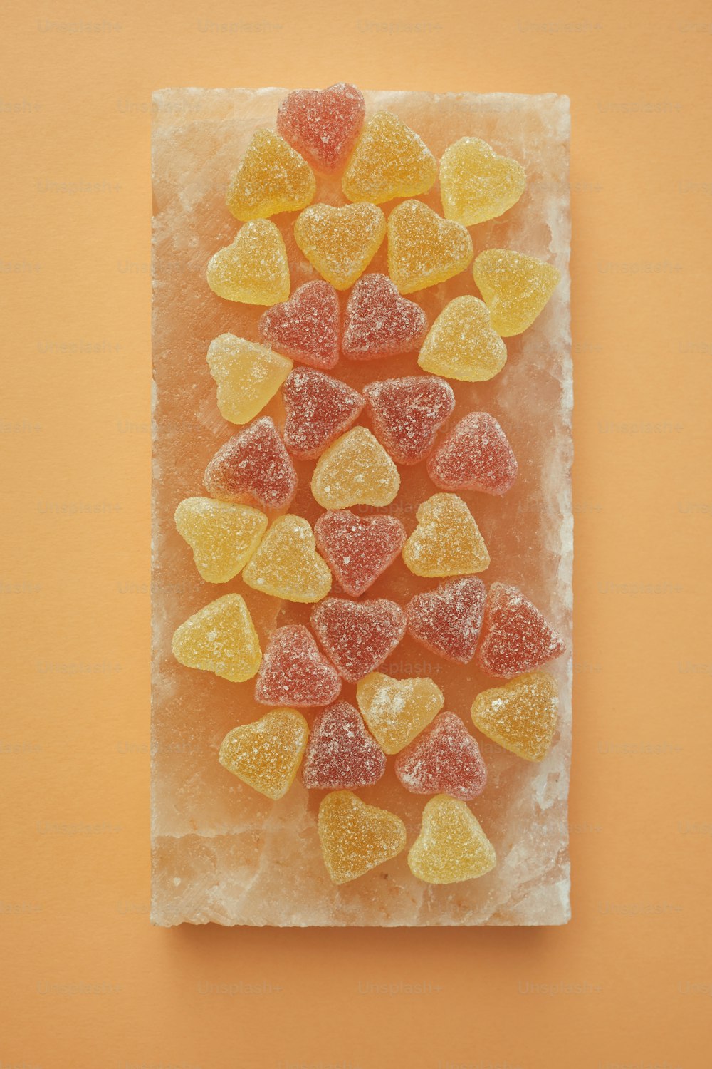 gummy bears arranged on a piece of ice