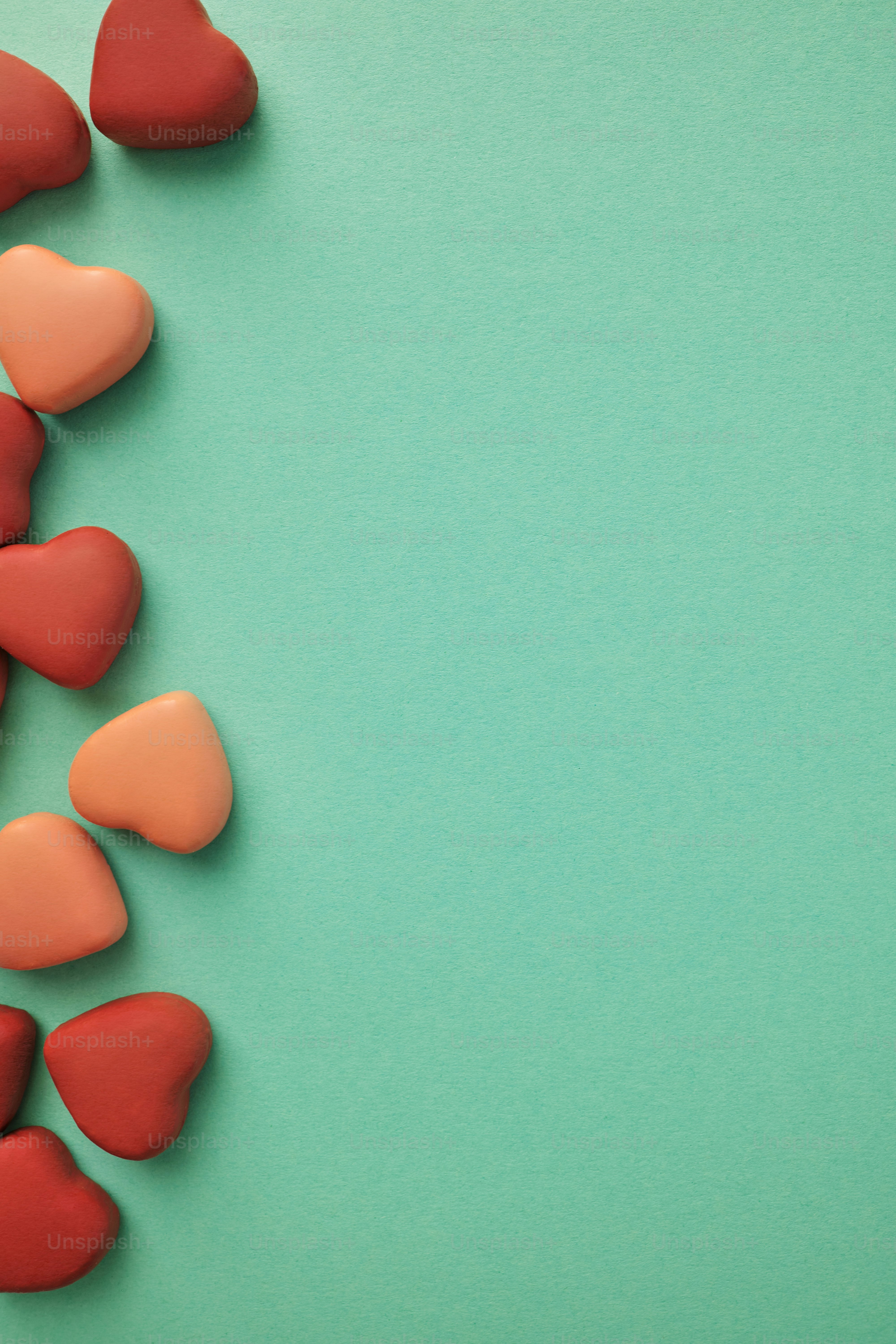 a group of hearts sitting on top of a green surface