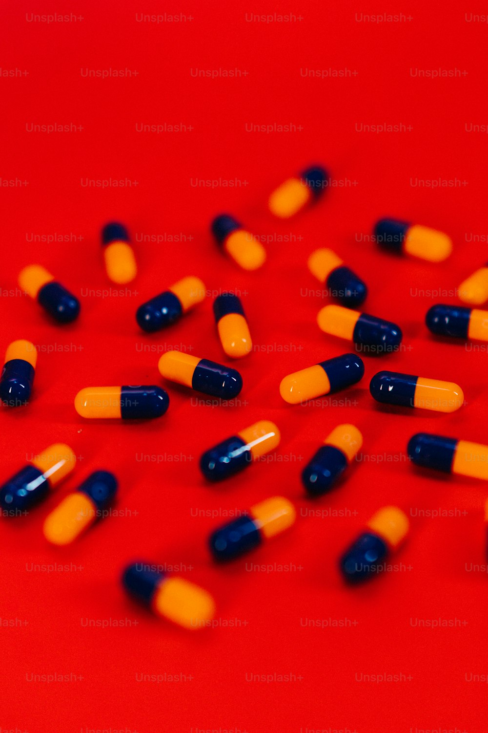 a bunch of pills sitting on top of a red table