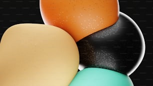 a group of different colored eggs on a black background