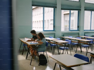 a couple of people that are sitting at desks