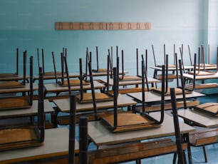 a room filled with lots of wooden desks