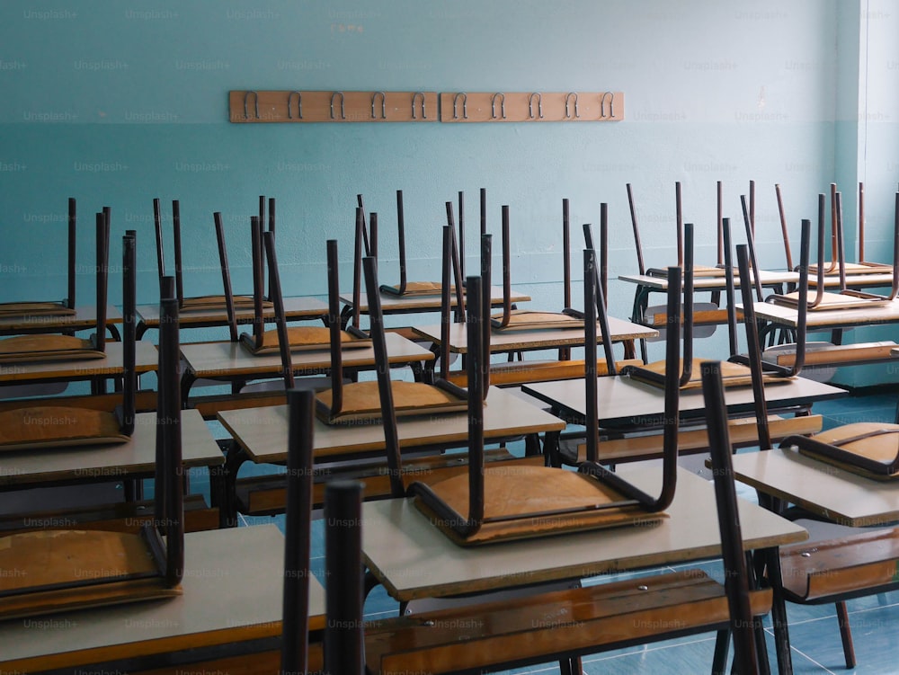 a room filled with lots of wooden desks