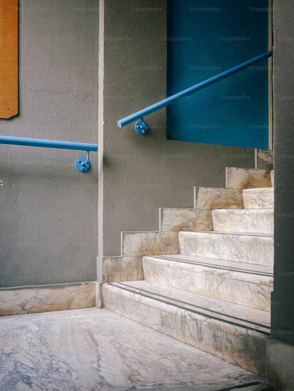 a set of stairs leading up to a blue door