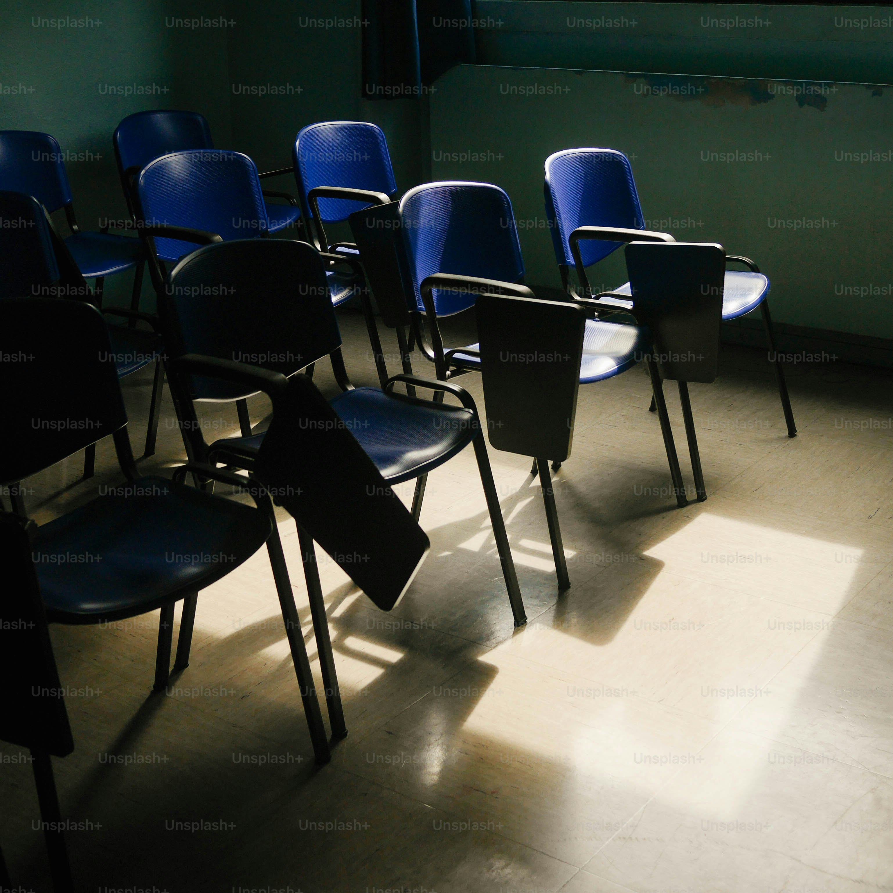 a row of blue chairs sitting in a room